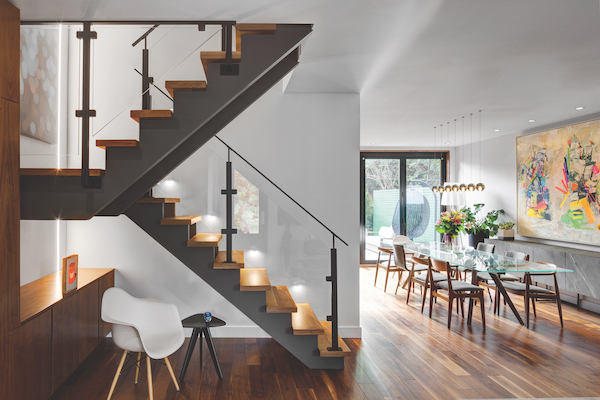 Scissor stairs leading to long dining table