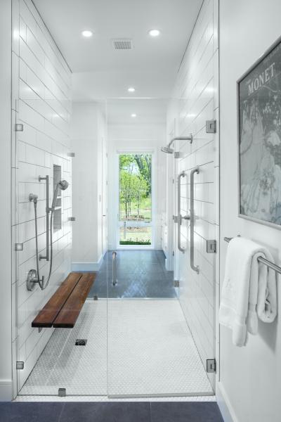 White tile shower stall with bench